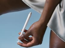 Woman demonstrating how to insert VS-01 smart tablets using the applicators