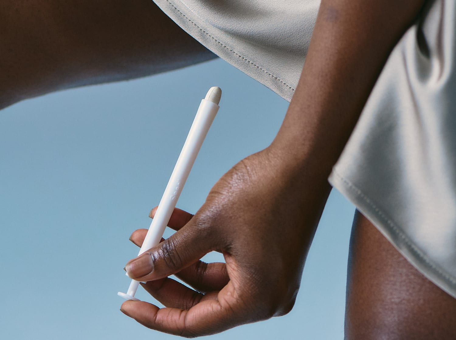 Woman demonstrating how to insert VS-01 smart tablets using the applicators