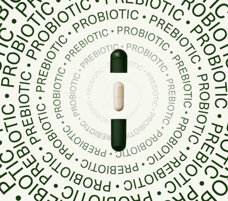 Capsule with green outer shell and white inner capsule surrounded by "prebiotic" and "probiotic" text.