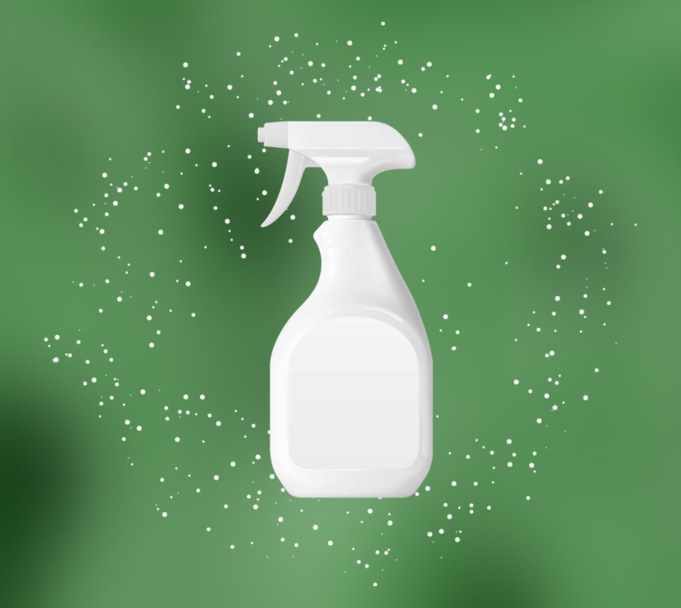 White spray bottle with blank label on green background with white speckles around it