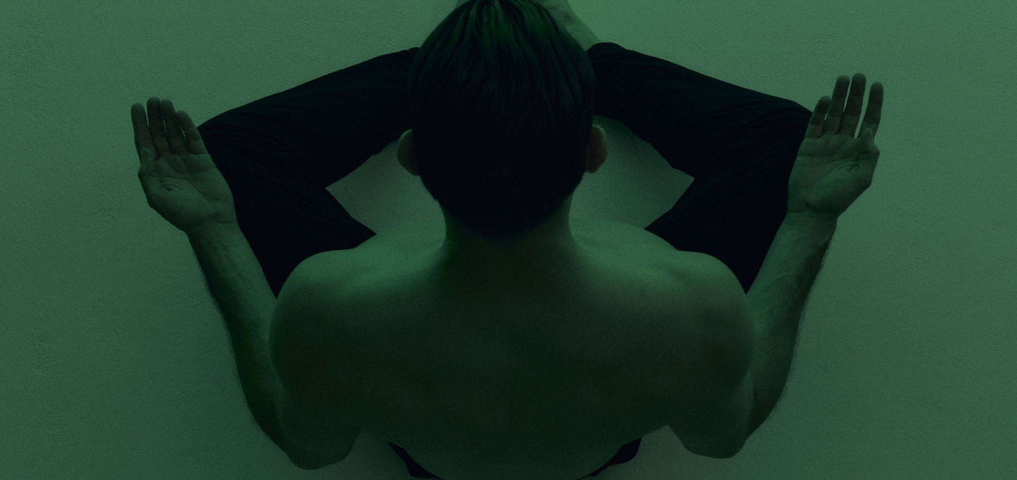 person meditating with green filter overlay