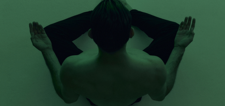 person meditating with green filter overlay