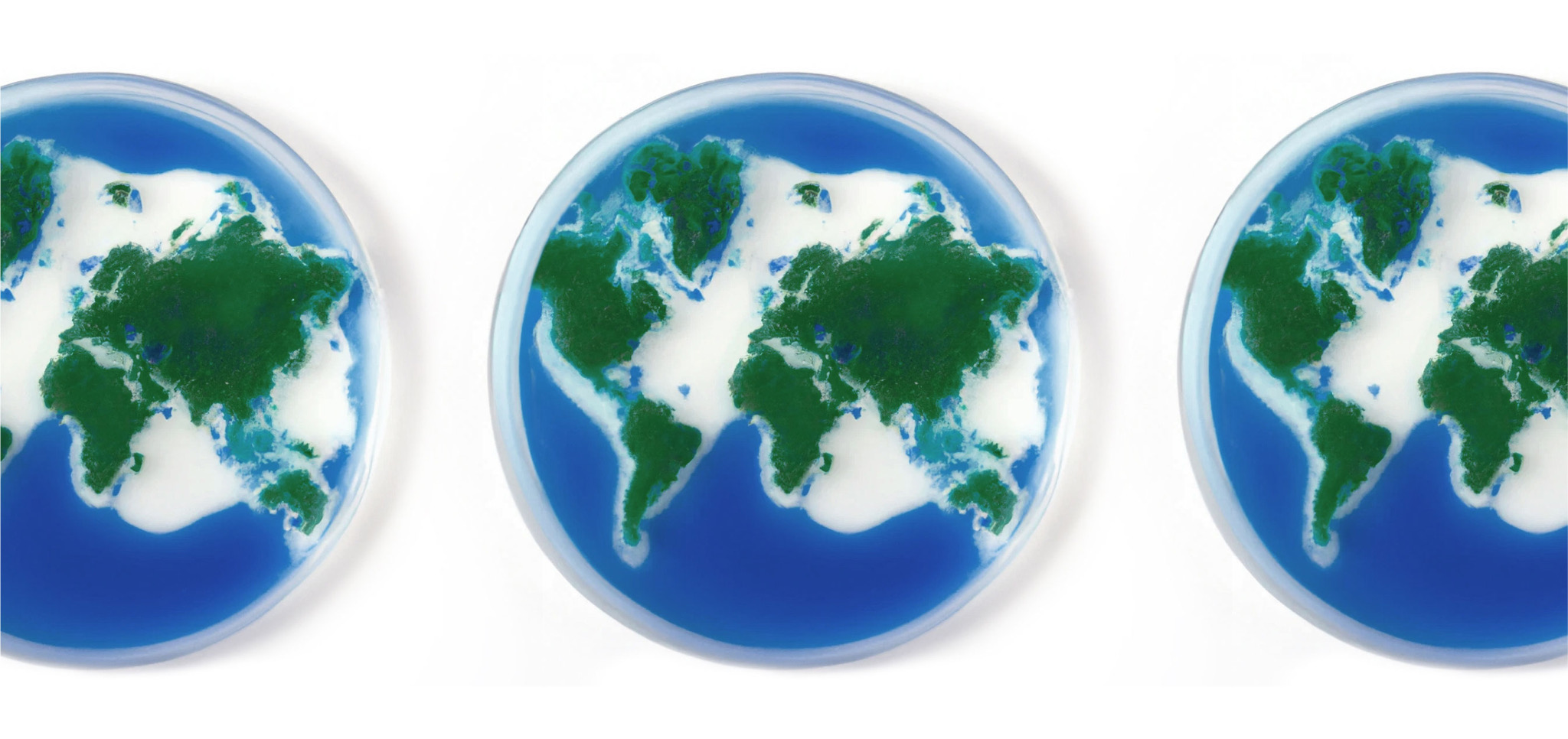 Three petri dishes with green and blue Earth-like land and water patterns.