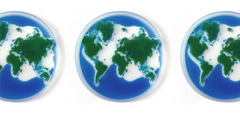 Three petri dishes with green and blue Earth-like land and water patterns.