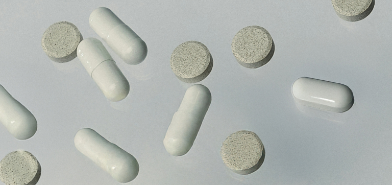 different shaped pills on neutral background